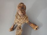 a small stuffed animal made out of a piece of wood