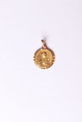 a close up of a gold coin on a white surface