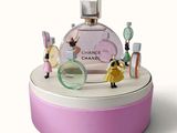 a bottle of chanel perfume on top of a pink box