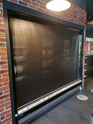 une grande fenêtre au milieu d'un mur de briques