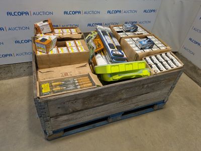 a wooden crate filled with assorted items in front of a wall