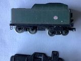four different types of toy trains on a white surface