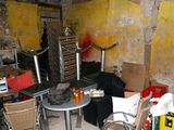 an image of a cluttered room with a table and chairs