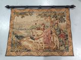 a tapestry hanging on the wall with a picture of a man on a horse