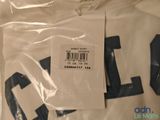 the shirt is white and has a black number on it