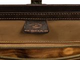 the inside of a brown leather bag with a brown handle