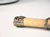 a wooden stick with a ring on it on a table