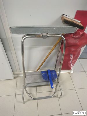 un balai et un porte-balai dans un coin de la pièce