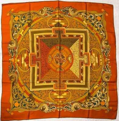 a close up of a square scarf with a design on it