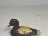 a plastic duck that is sitting on the ground