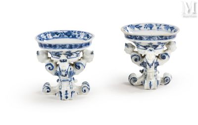 two blue and white vases sitting next to each other