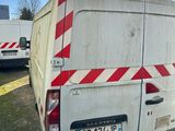 a white van with red and white stripes parked in a parking lot