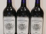 three bottles of wine sitting on top of a table next to each other