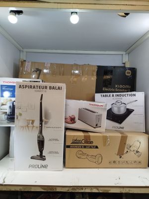 many boxes of kitchen appliances on a shelf in a room