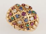 an image of a gold ring with multi colored stones