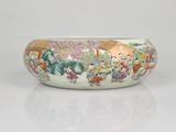 chinese famille bowl with figures and flowers on a white background