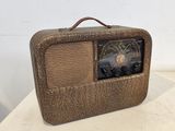 an old fashioned radio sitting on top of a table next to a wall