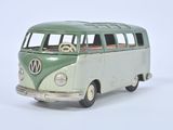 a green and white toy bus on a white surface