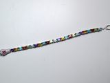 a close up of a beaded bracelet on a white surface