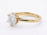 a yellow gold engagement ring with a round brilliant cut diamond