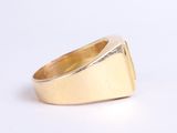 a close up of a gold ring on a white surface