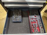 a tool box with tools inside of it on the floor