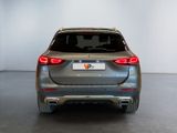 the rear end of a silver bmw suv parked in a garage