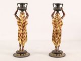 pair of antique african figurines of women carrying pots on their heads