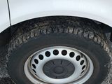 a white van with a flat tire parked on the street