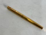 a close up of a pen on a table with a white background