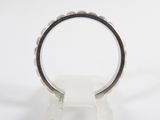 silver ring with a black band on a white marble base