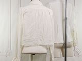 a mannequin in front of a white shirt on a mannequin stand
