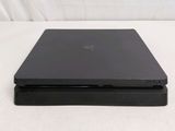 a black laptop sitting on top of a white table