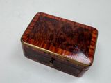 a small wooden box that is on a white surface