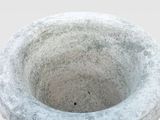 a stone bowl with a hole in the middle of it