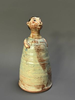 a ceramic vase with a cat on the top of it