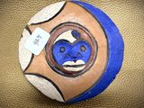 a rock with a face painted on it sitting on a table