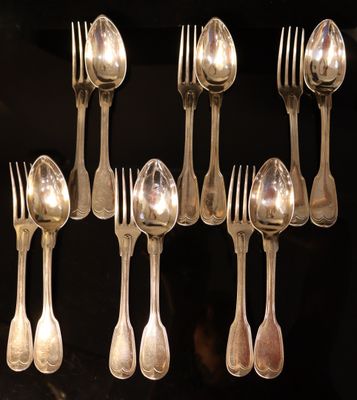 a lot of silver spoons and forks on a table