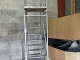 a metal ladder that is next to a box in a garage