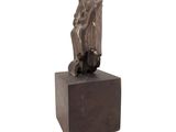 an image of a sculpture of a person sitting on top of a block