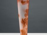 a glass vase that has a brown and white design on it