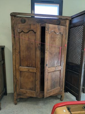 a wooden armoire with a mirror on top of it