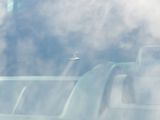 a plane that is flying in the sky through the clouds