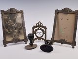three antique picture frames and a stamper on a table
