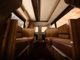 two beds in the back of a bus with a brick wall