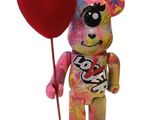a teddy bear holding a heart shaped balloon on a stick