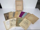 an assortment of old books sitting on top of a white table