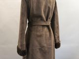 the back view of a woman ' s coat with a fur collar