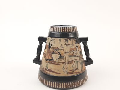 a vase with a painting on it sitting on a table
