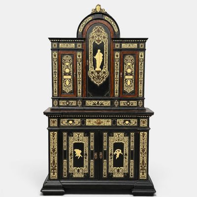 a black and gold cabinet with a clock on top of it